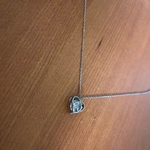 Silver heart shaped necklace with Diamond in center